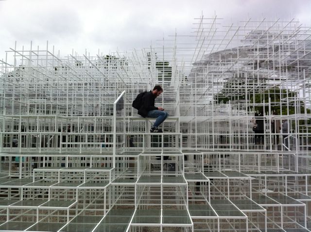 An image showing someone sitting half way up the Serpentine Pavilion