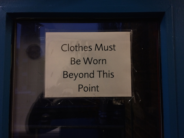 A sign that says 'Clothes Must Be Worn Beyond This Point'