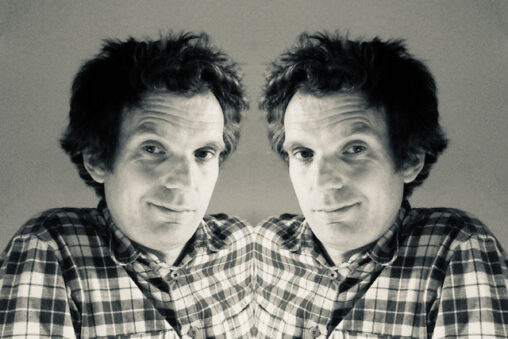 Image of Oliver Broadbent using a reflection filter to create a mirror image of himself - purpose is to illustrate a post about reflective workshops