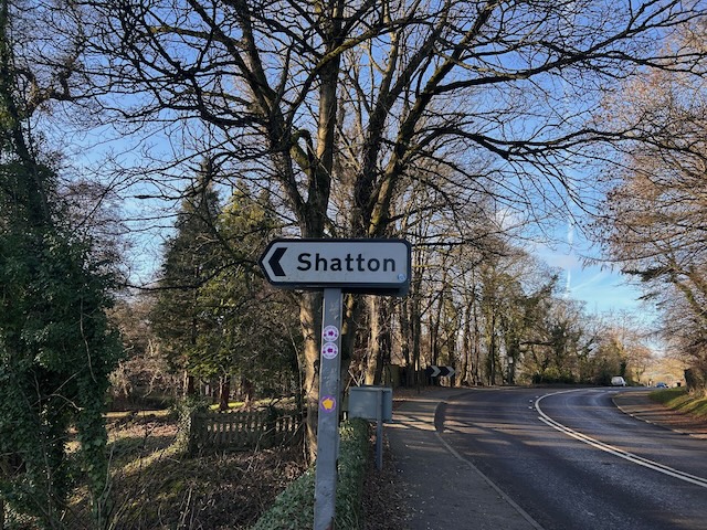 Road sign giving directions to a town called Shatton